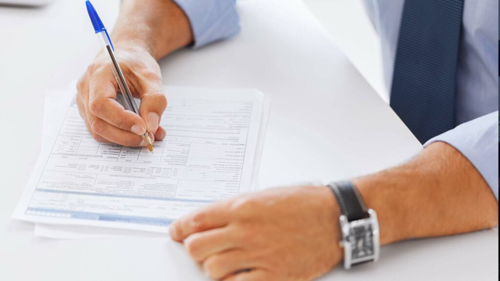 Closeup of man businessman filling out paperwork