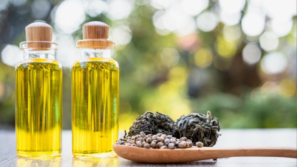 Bottles of CBD liquid and wooden spoon.