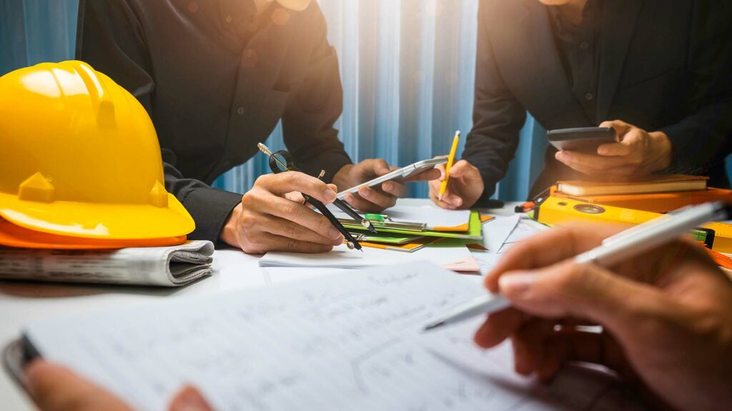 Group of architects reviewing documents at a table.