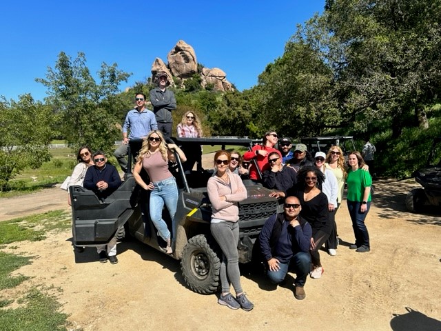 Admiral's Underwriting Team posing on a jeep