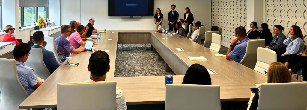 Admiral employees sitting around a conference table during a meeting