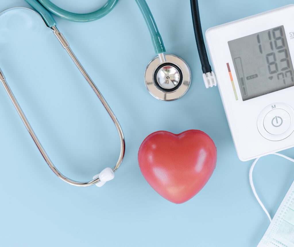 Overhead view of stethoscope, heart monitor and heart shaped stress ball