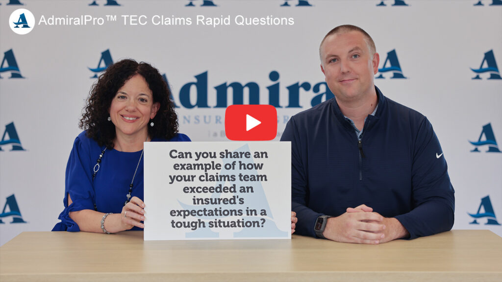 Julie Kriegel & Nate Hartman sitting at a table answering questions printed on signs