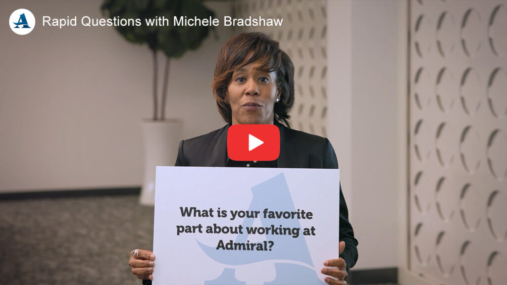 Michele Bradshaw holding signs with Rapid Questions