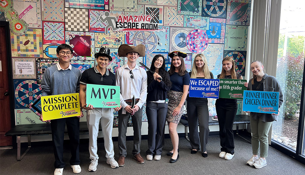 Moorestown office interns celebrating after winning an escape room.