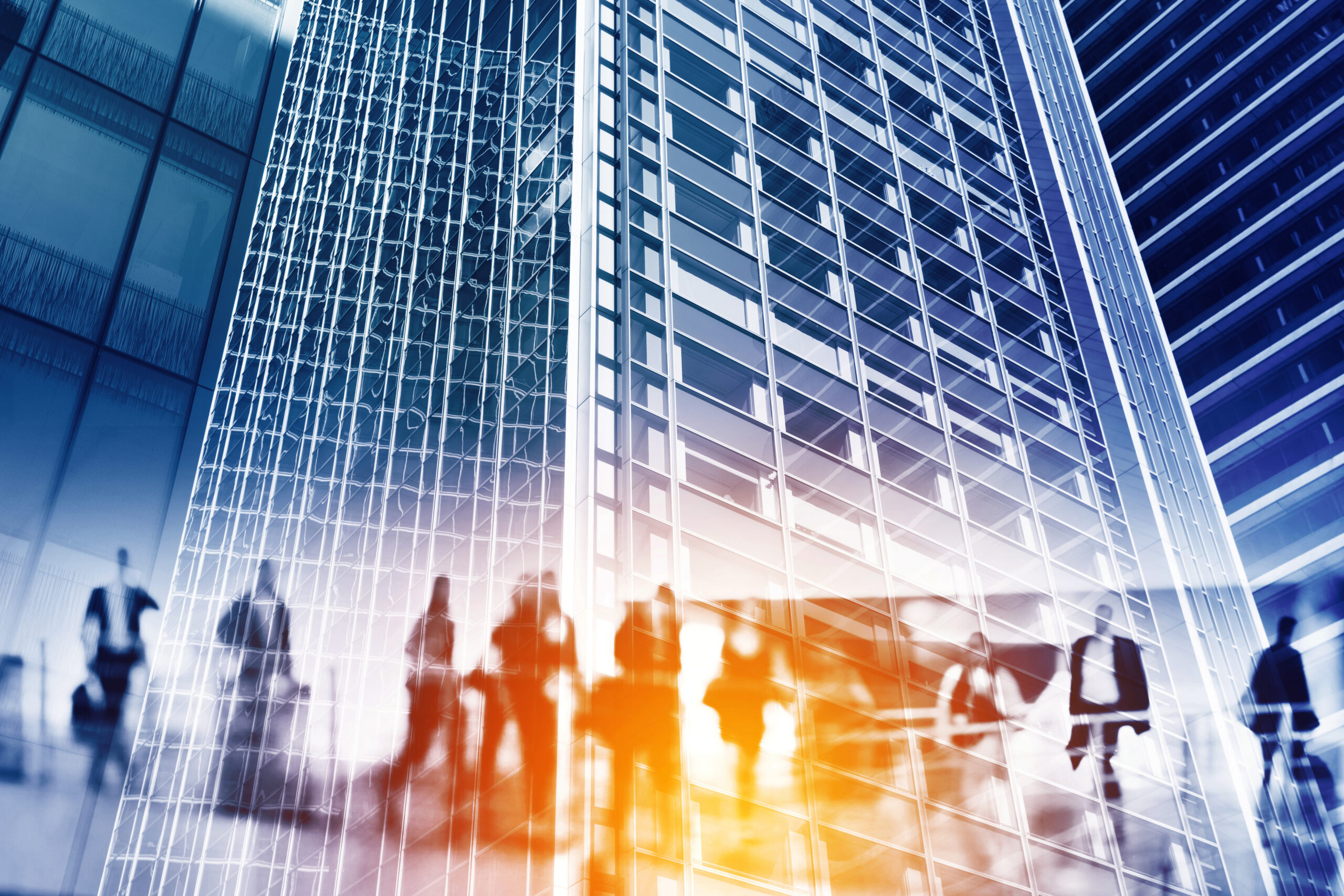 Blurred image of building with people walking in front.