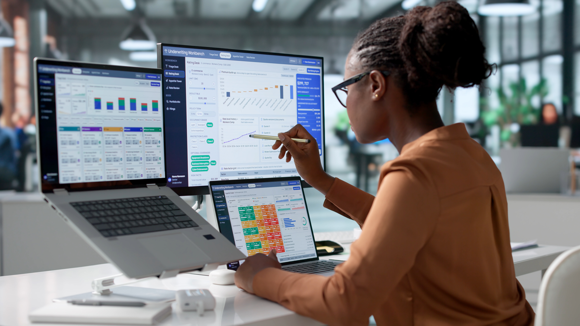 Woman looking at multiple computer screens.